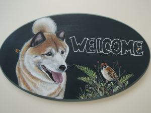 ペットロスの方がペットのリアルな似顔絵の注文（オーダー）前に見る作品～元気に笑う愛犬と草花に止まる小鳥を描いたウエルカムボードのグッズ